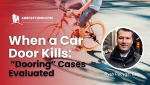 Advertising banner for ArrestedMN, featuring a speeding cyclist on a red-blue background and a circular portrait on the right, with a bold headline about car-dooring cases evaluating claims.